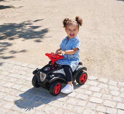 Big Bobby Car Classic Little Rocker - Rutschauto ab 1 Jahr im dunklen Rock n‘ Roll-Design mit rotem Sicherheits-Lenkrad und Hupe, für Kinder ab 12 Monaten (bis 50 kg), schwarz mit Aufklebern